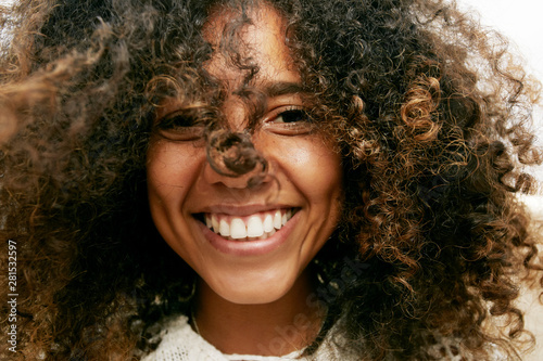 Portrait of smiling woman with curly hair photo