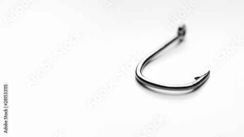 Fishing hook on white background, shallow depth of field