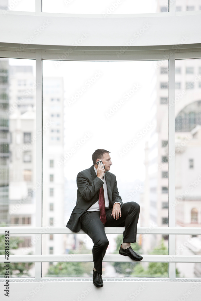 Businessman talking on smartphone in convention center