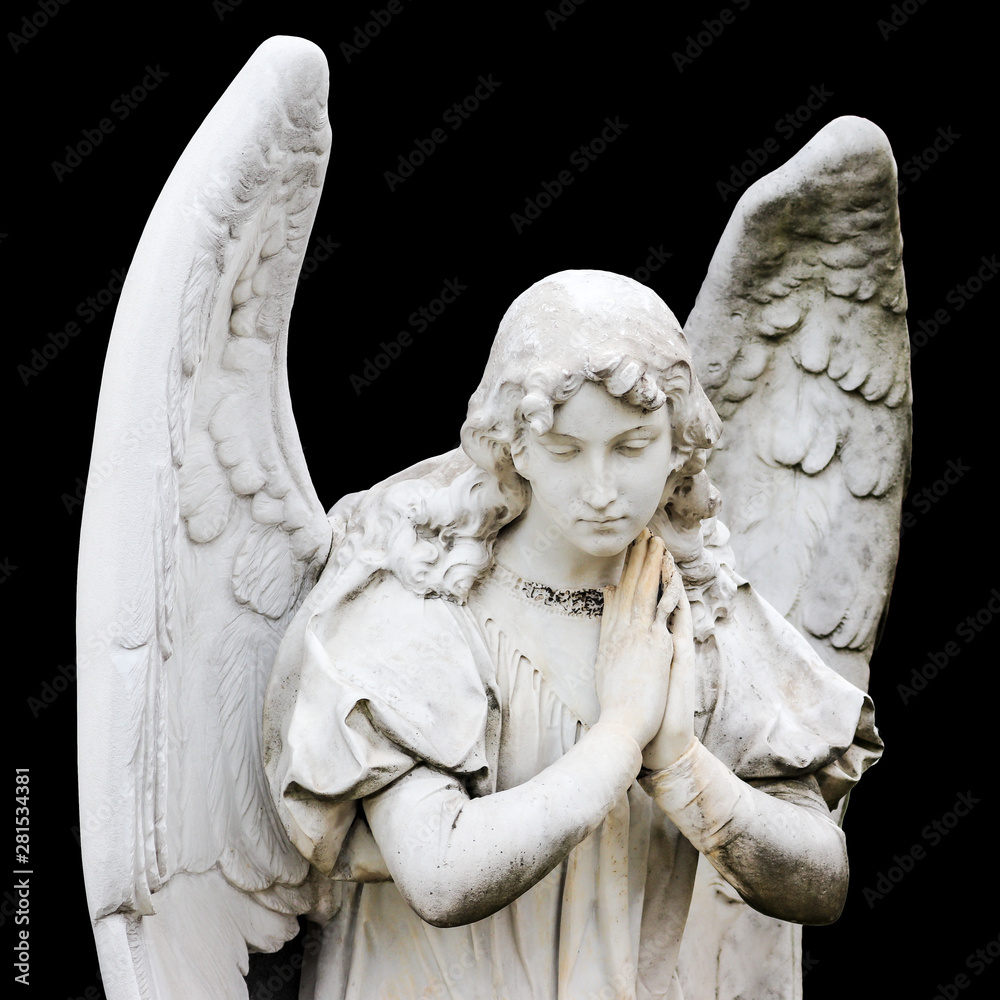 Guardian angel sculpture with open wings isolated on black background.  Angel sad expression sculpture with eyes down and hands together in front  of chest. Color photo. Non-modern religious statue. Photos | Adobe