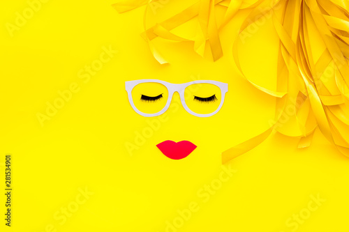 Visagiste work space with face model on yellow background top view copyspace
