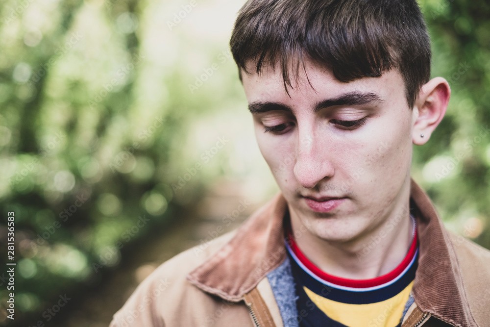 Teenage boy standing in forest Teenage boy standing in forest