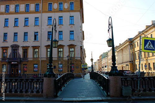 Fototapeta Naklejka Na Ścianę i Meble -  a small bridge with lights across the canal on the street in St. Petersburg