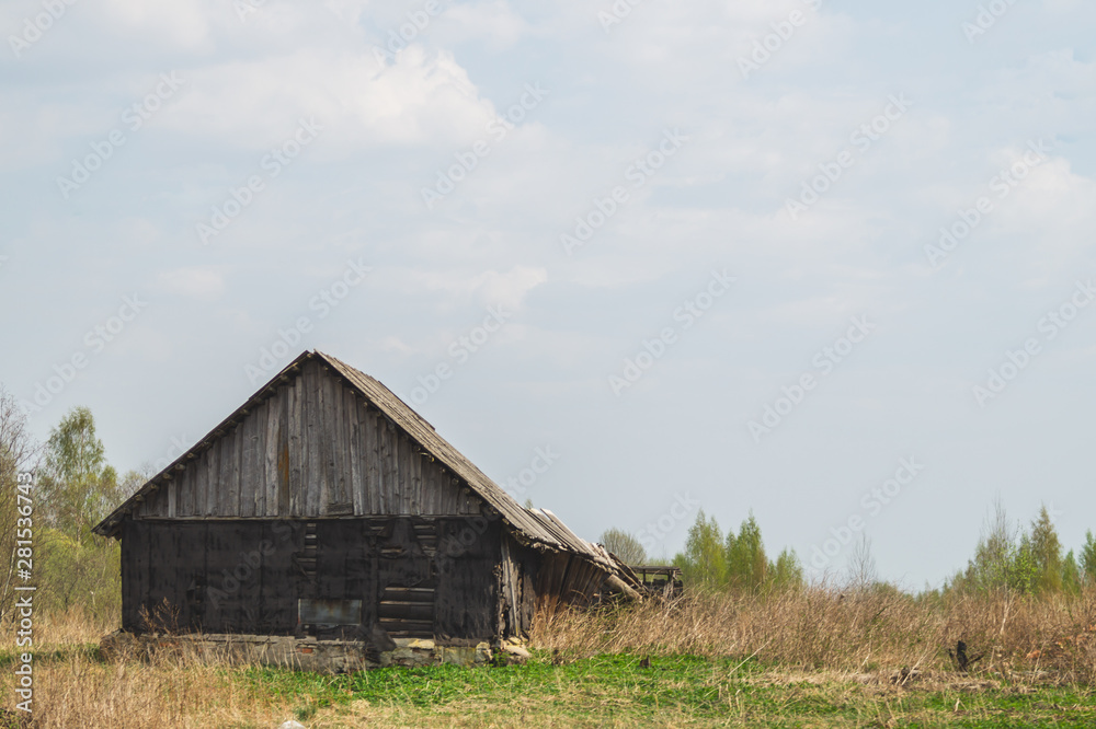 Old wooden house in the countryside. the house stands alone in the field Old wooden house in the countryside. the house stands alone in the field