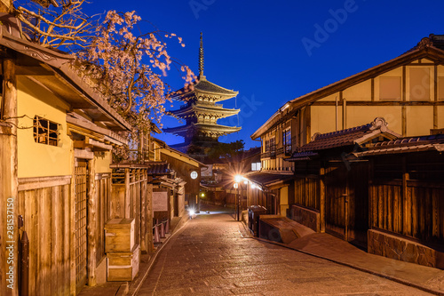 Exterior view of traditional houses with pagoda at night photo