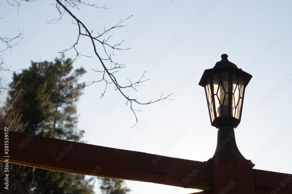 Retro street lamp at sunset. Vintage lantern at evening light