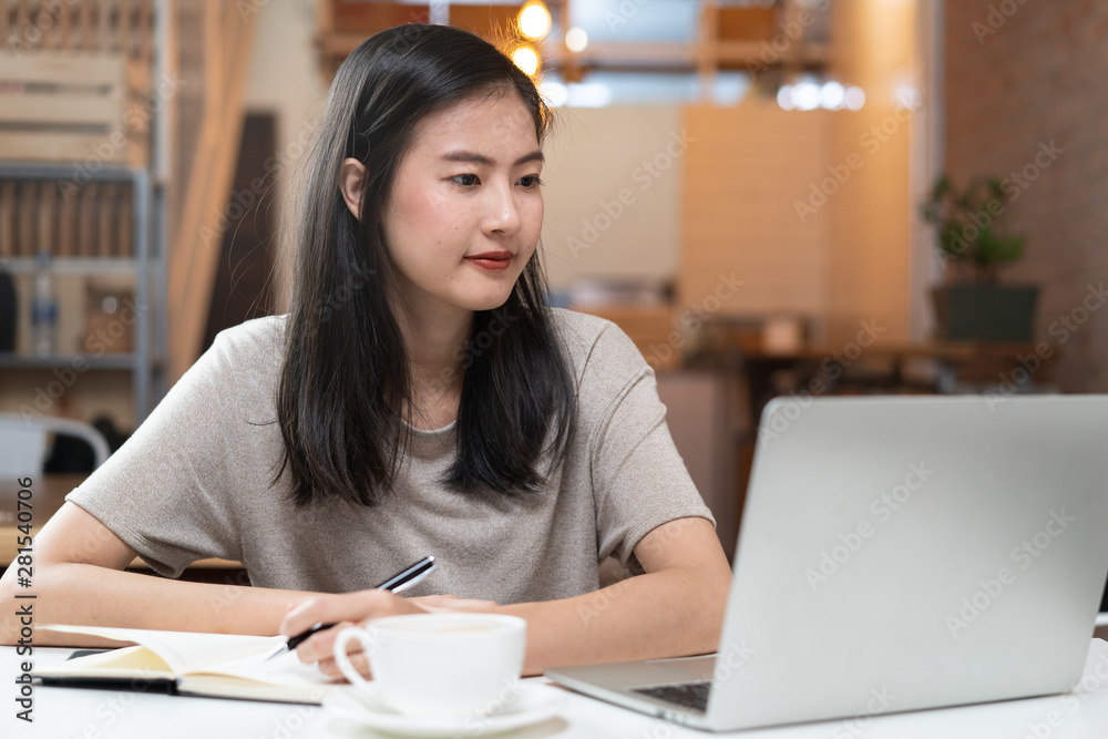 freelancer asian girl working at co-working space. freelancer asian girl working at co-working space.