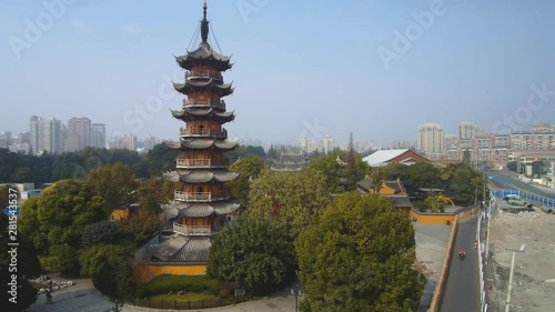 Aerial ascending forward view of Shanghai's most famous pagoda, Longhua Pagoda photo