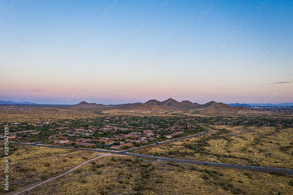 Aerial view of a desert community in Arizona during the golden hour at sunset.