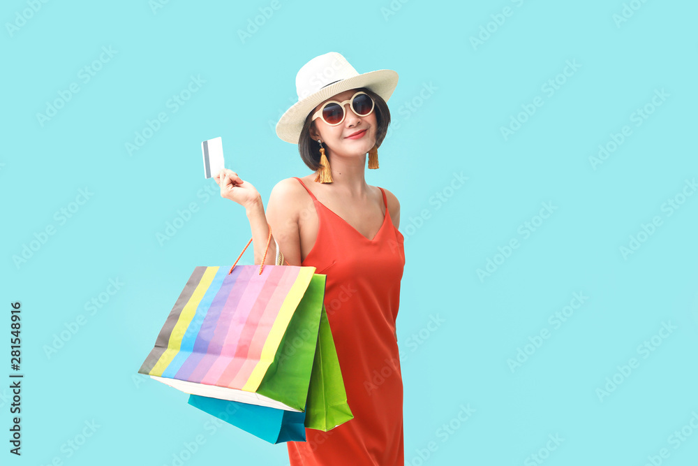 Portrait of asian girl wearing dress and sunglasses holding shopping bags. Portrait of asian girl wearing dress and sunglasses holding shopping bags.