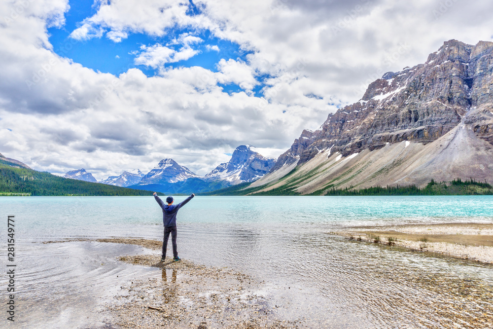 Man at Bow Lake With Crowfoot Glacier and Crowfoot Mountain