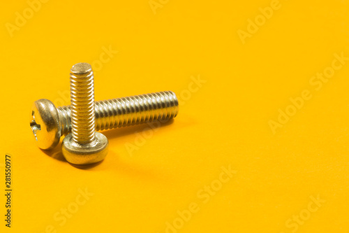 Fototapeta Naklejka Na Ścianę i Meble -  Screws on a yellow background. pile of fasteners