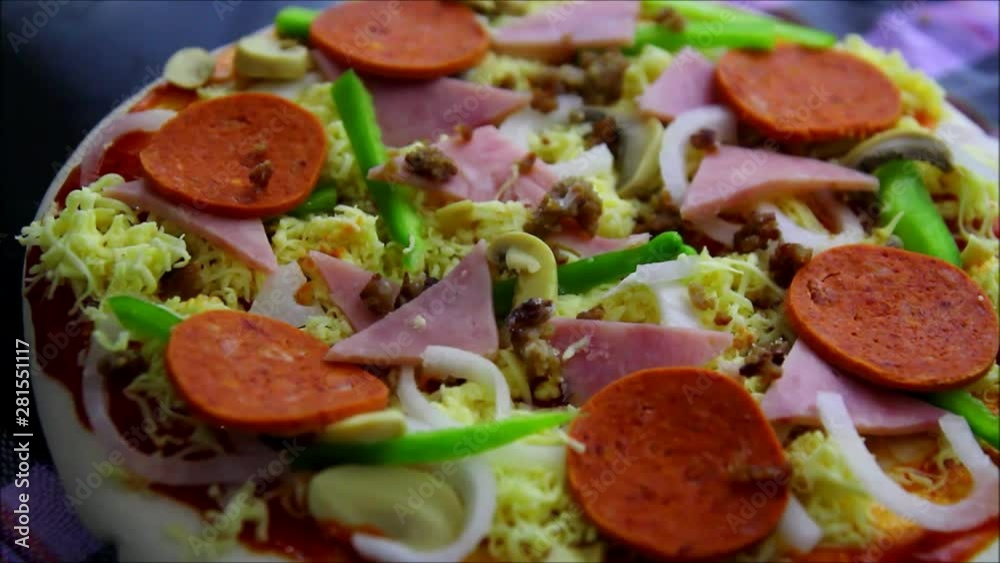 Tilt up video shot of a vegetable and meat pizza Tilt up video shot of a vegetable and meat pizza