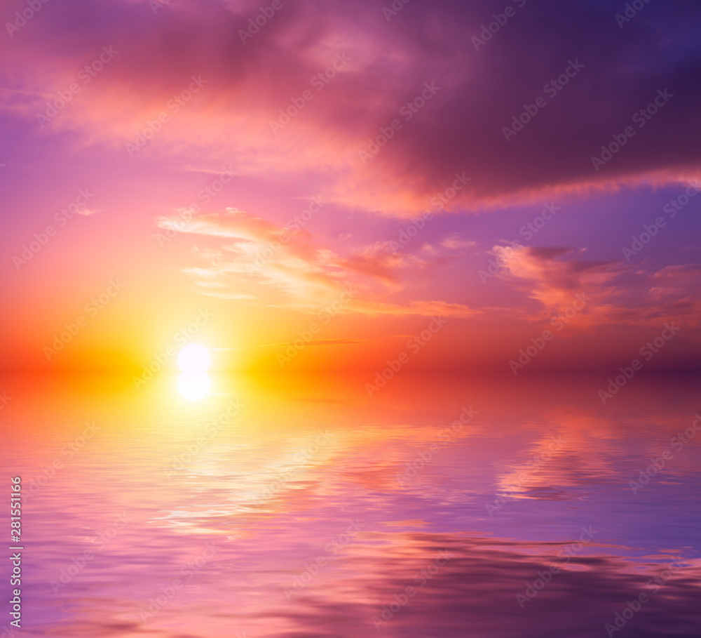 Fototapeta premium Beautiful pink sea sunset with bright sun and clouds.