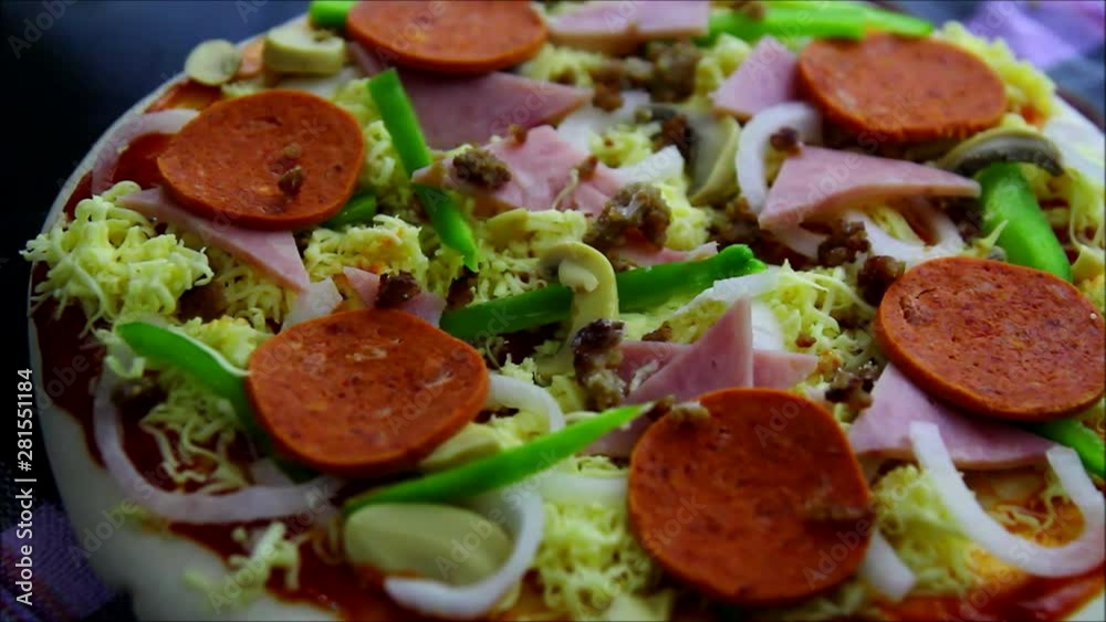 Steady video shot of a vegetable and meat pizza Steady video shot of a vegetable and meat pizza