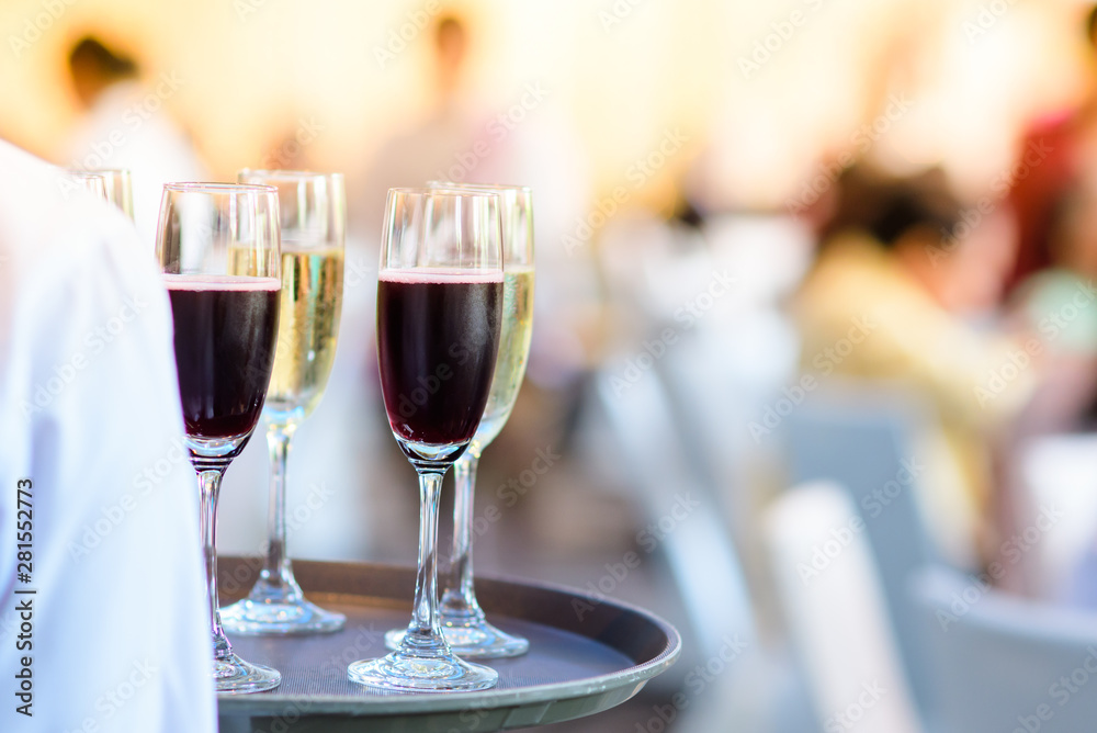 Restaurant staff Holding a glass of wine ready to serve at a party Restaurant staff Holding a glass of wine ready to serve at a party