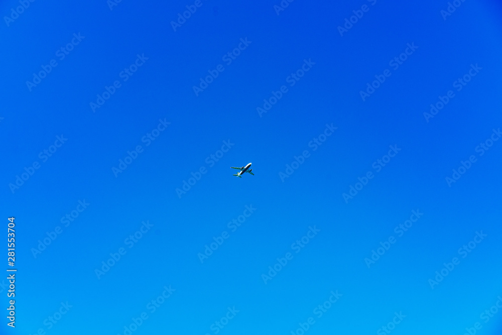 Airplane centered on a bright blue sky Airplane centered on a bright blue sky