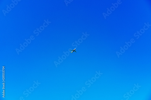 Airplane centered on a bright blue sky