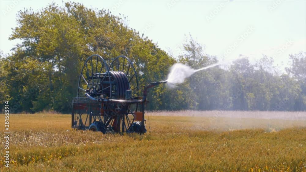 Close up irrigator slow motion watering fields Close up irrigator slow motion watering fields