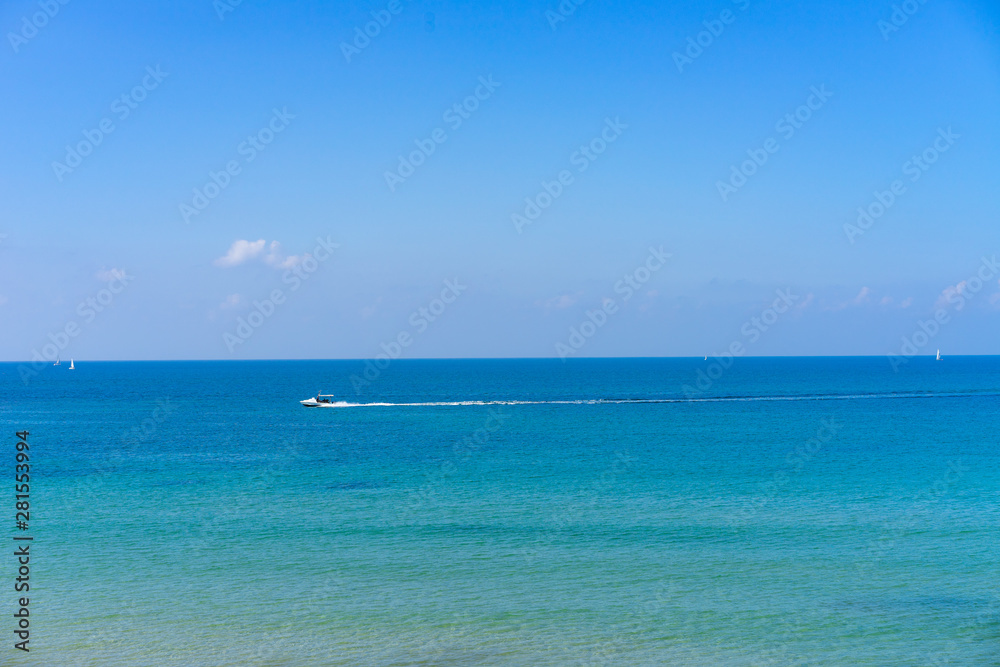 Boat going across a blue ocean