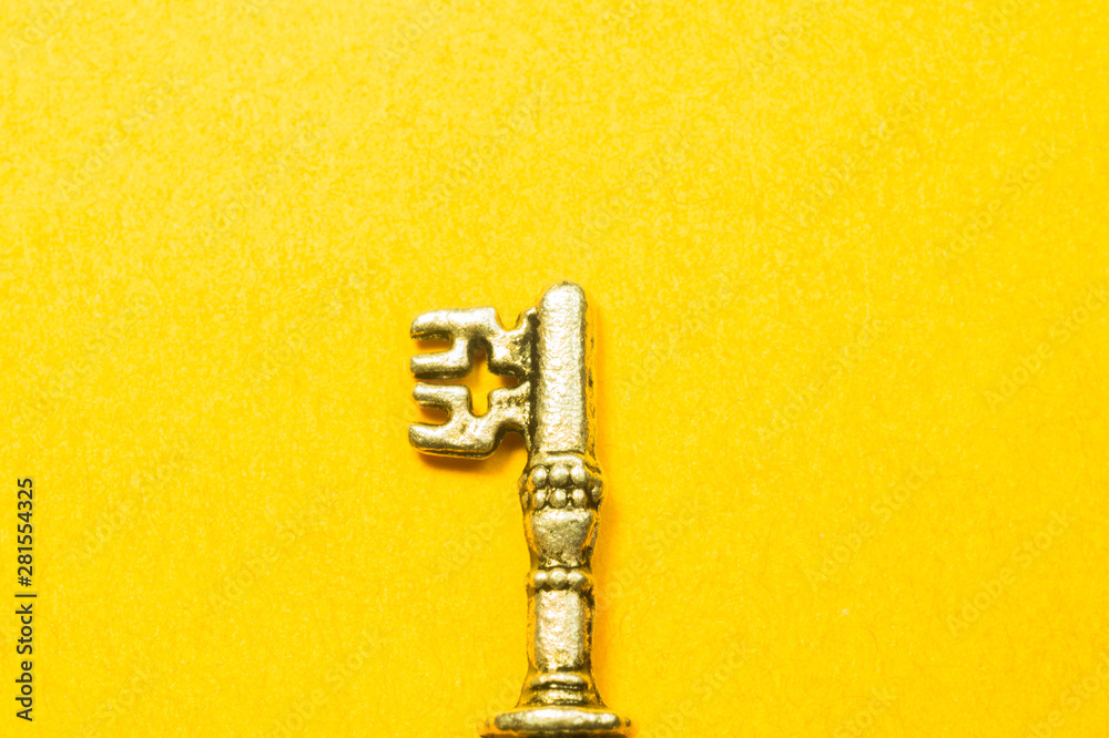 Vintage key isolated on yellow background