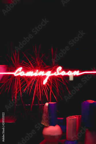 Neon sign that reads coming soon