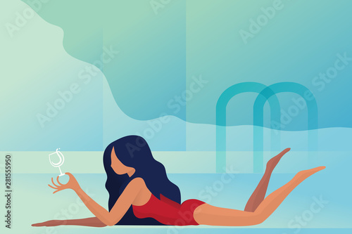 beautiful girl lying on the beach with a glass of wine