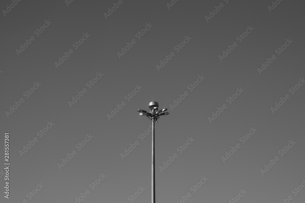 Street lamp post standing alone on the sky background black and white Street lamp post standing alone on the sky background black and white