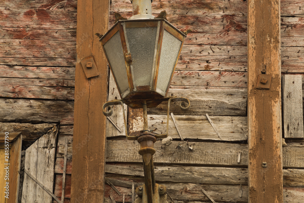 Windows of the old wooden house. wooden wall with vintage lamp