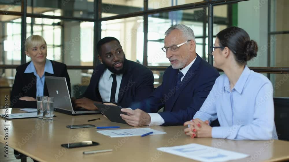 Multiracial office partners celebrating good news, business app release, success Multiracial office partners celebrating good news, business app release, success