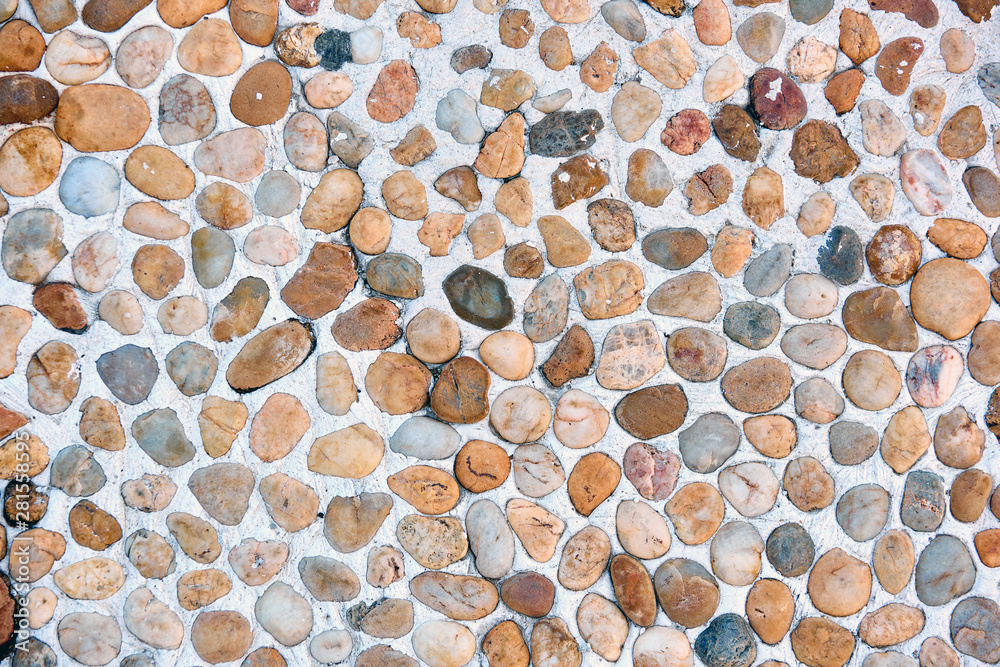 The texture of sea pebbles in cement closeup. The texture of sea pebbles in cement closeup.