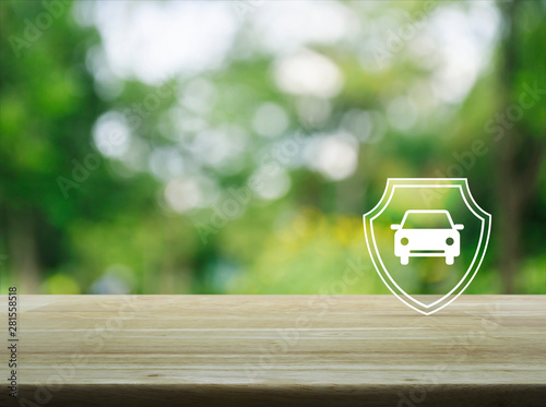 Car with shield flat icon on wooden table over blur green tree in park, Business automobile insurance concept © grapestock