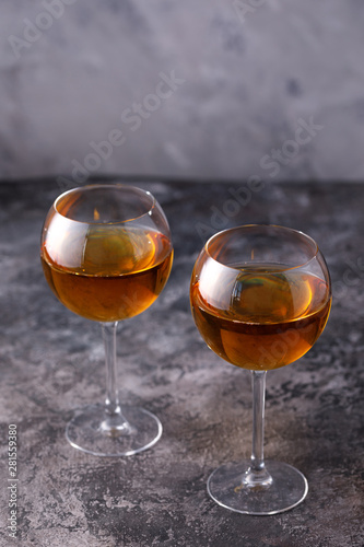 Two glasses with white wine on a textural background. Copy space. Place for your text.