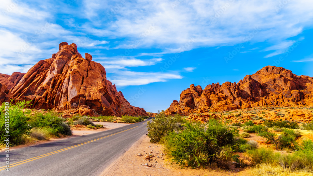 The Mouse's Tank Road surrounded by Red Aztec Sandstone Mountains in the Valley of Fire State Park in Nevada, USA