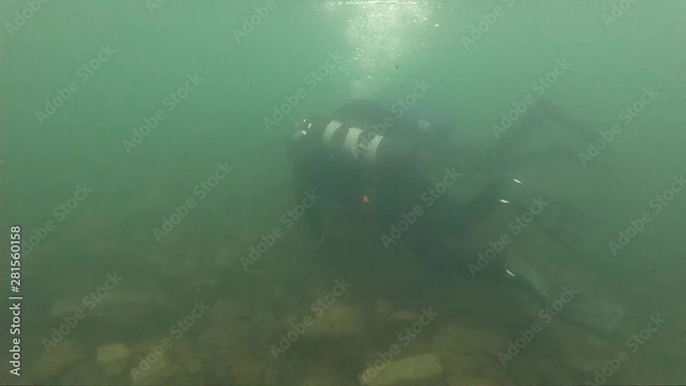 first dive in cold water, diving instructor conducting a shallow water scuba diving course in a Mountain Lake first dive in cold water, diving instructor conducting a shallow water scuba diving course in a Mountain Lake