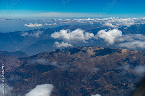 Mountain range above the clouds from an airplane