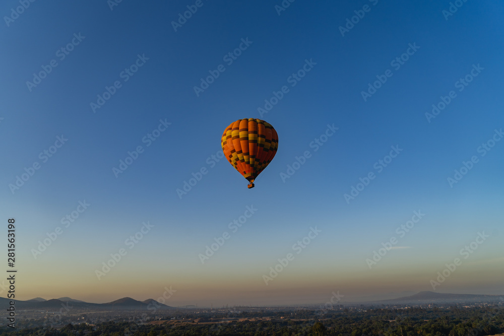 Hot air balloon high in the bright blue sky