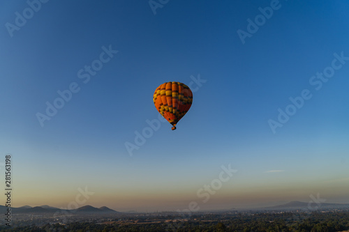 Hot air balloon high in the bright blue sky
