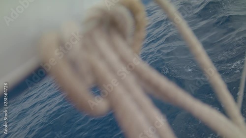 Sailboat glides to meet the Wind Sail Yacht moving on calm waves of the ocean Maritime Knot as part of a ship’s outfit Sheet weighs on bow pullpit light breeze caressed the sides of ship Shot URSA4.6K photo