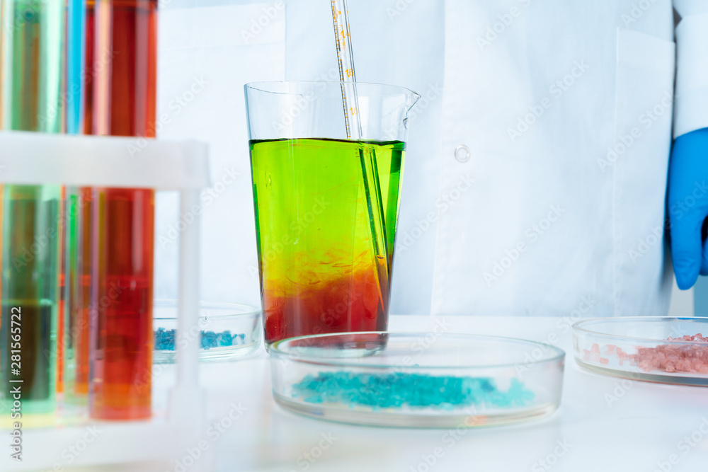 Manipulations with laboratory glass chemical containers on table Manipulations with laboratory glass chemical containers on table