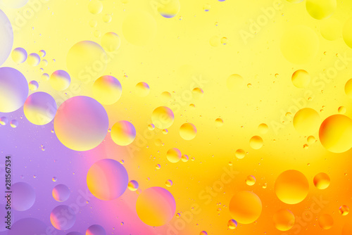 bright oily drops in water with colorful background  close-up 