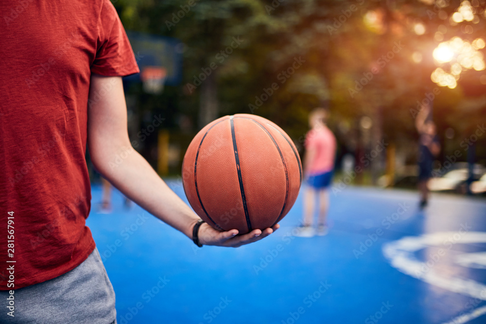 Man holding basketball ball on the urban city court. Man holding basketball ball on the urban city court.