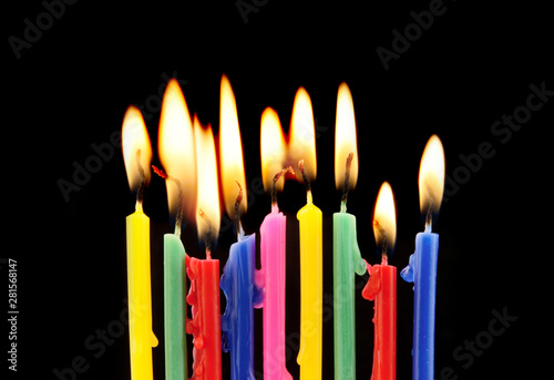 Colorful candles on black background