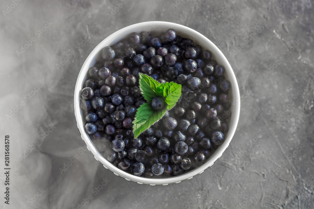Fresh organic blueberries in a bowl on dark background in smoky effect close up. Fresh organic blueberries in a bowl on dark background in smoky effect close up.