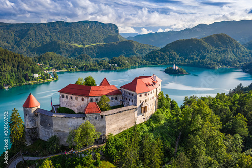 Bled, Slovenia - Aerial view of beautiful Bled Castle (Blejski Grad) with Lake Bled (Blejsko Jezero), the Church of the Assumption of Maria at background on a bright summer day