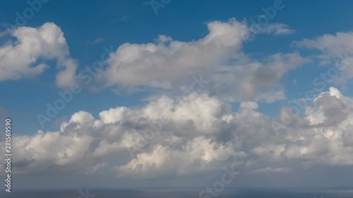 HD Time lapse of white summer clouds over ocean horizon Cloud running across the blue sky background photo