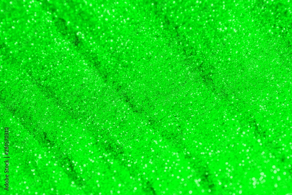 green shiny sand made of metallic glitters with selective focus and small bokeh texture - pretty abstract photo background green shiny sand made of metallic glitters with selective focus and small bokeh texture - pretty abstract photo background