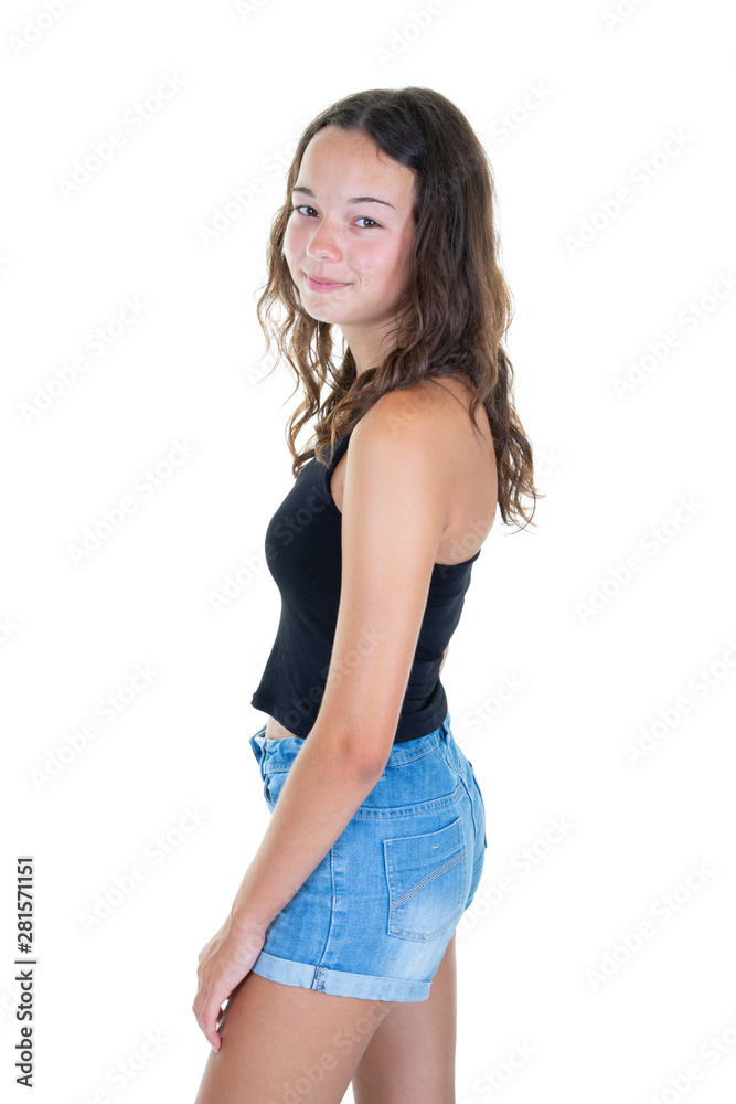 Young attractive teen girl smiling looking at camera side behind view in jeans short summer clothes Young attractive teen girl smiling looking at camera side behind view in jeans short summer clothes