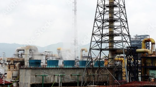 Factory exhausting fumes and steam in China still footage