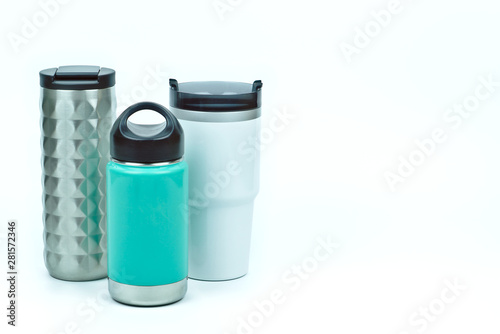 Isolated of three types of eco friendly and zero waste sport thermos stainless steel water bottles in teal white and silver color with black caps on white background with copy space on the right